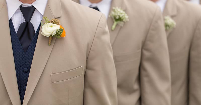 close up of groomsmen in tan sports jackets 