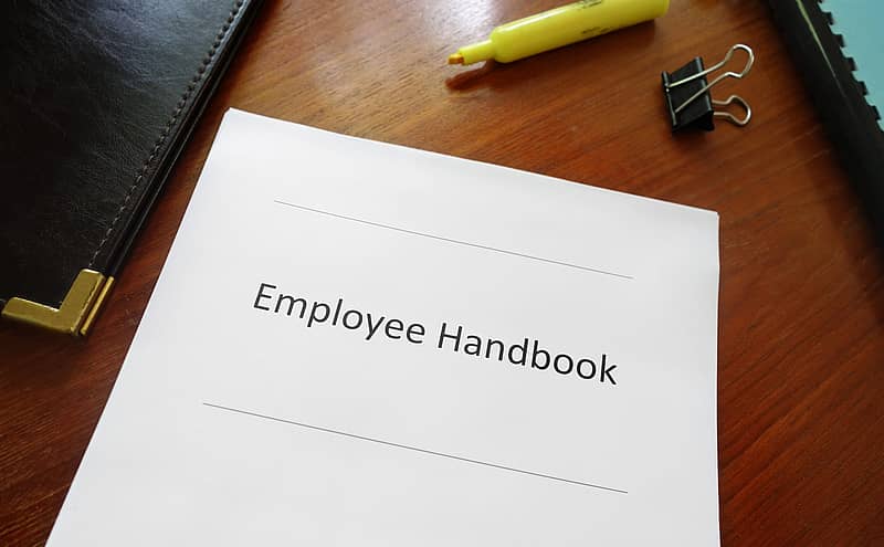 Employee handbook document on an office desk