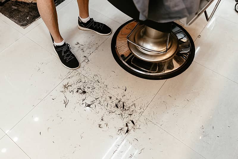 hair clippings on the floor of a salon 