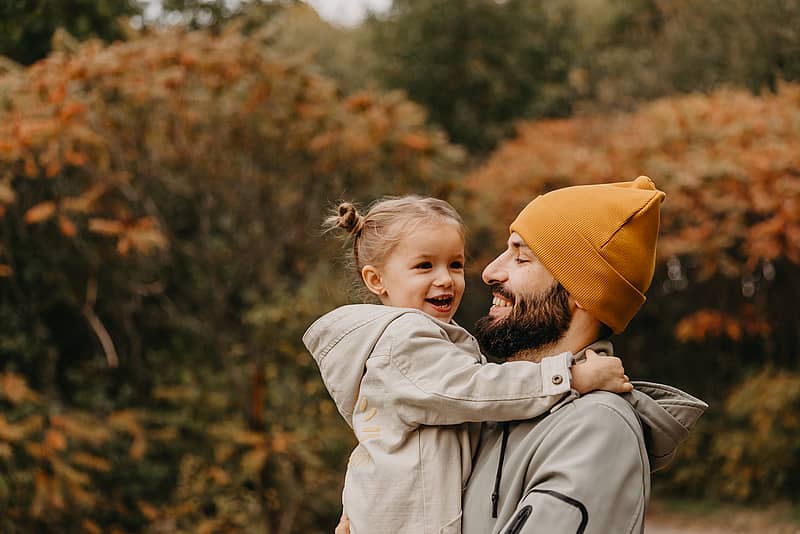 father and daughter enjoying time together in the fall