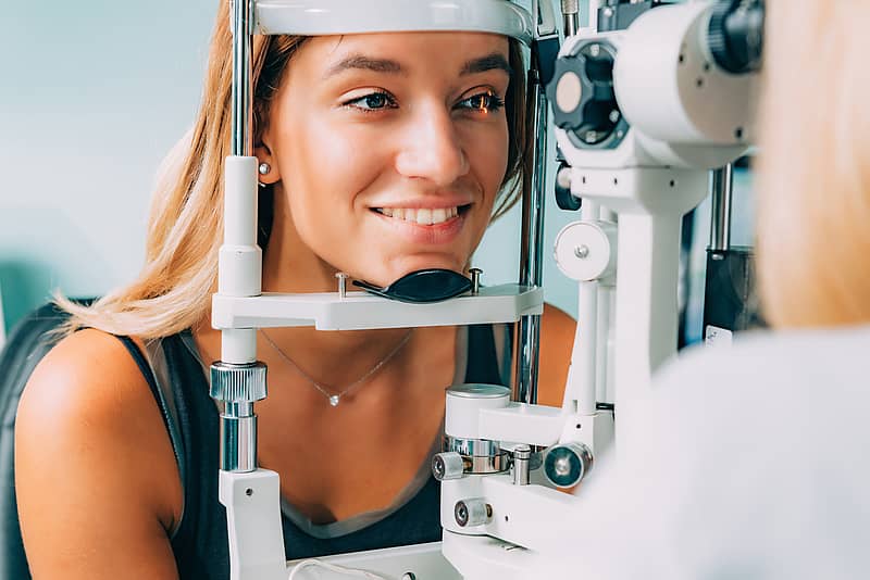 young patient taking eye pressure test at the optometrists