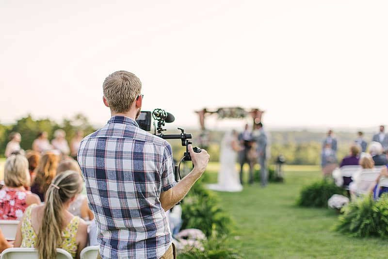 videographer capturing wedding from a distance