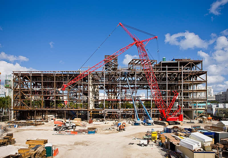 construction site with crane, equipment, and materials