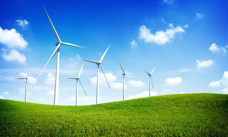wind mills on a grassy hill