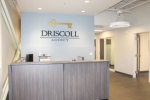 front desk with the words Driscoll printed on the wall