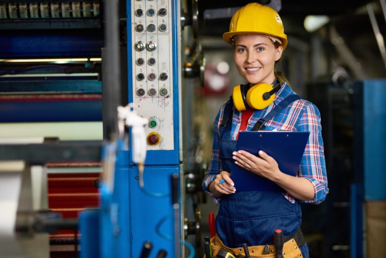 factory worker next to machinery