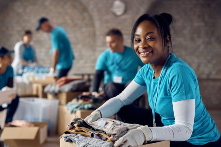 non-profit worker packing clothes into a box