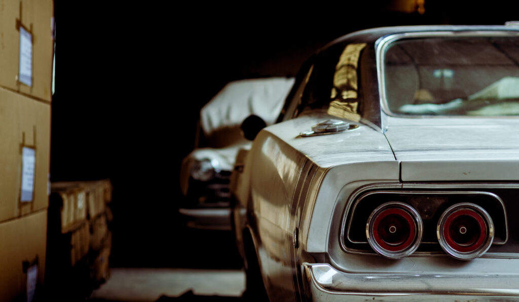 an antique car sits in a garage 