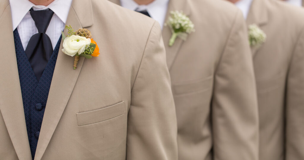 close up of groomsmen in tan sports jackets 