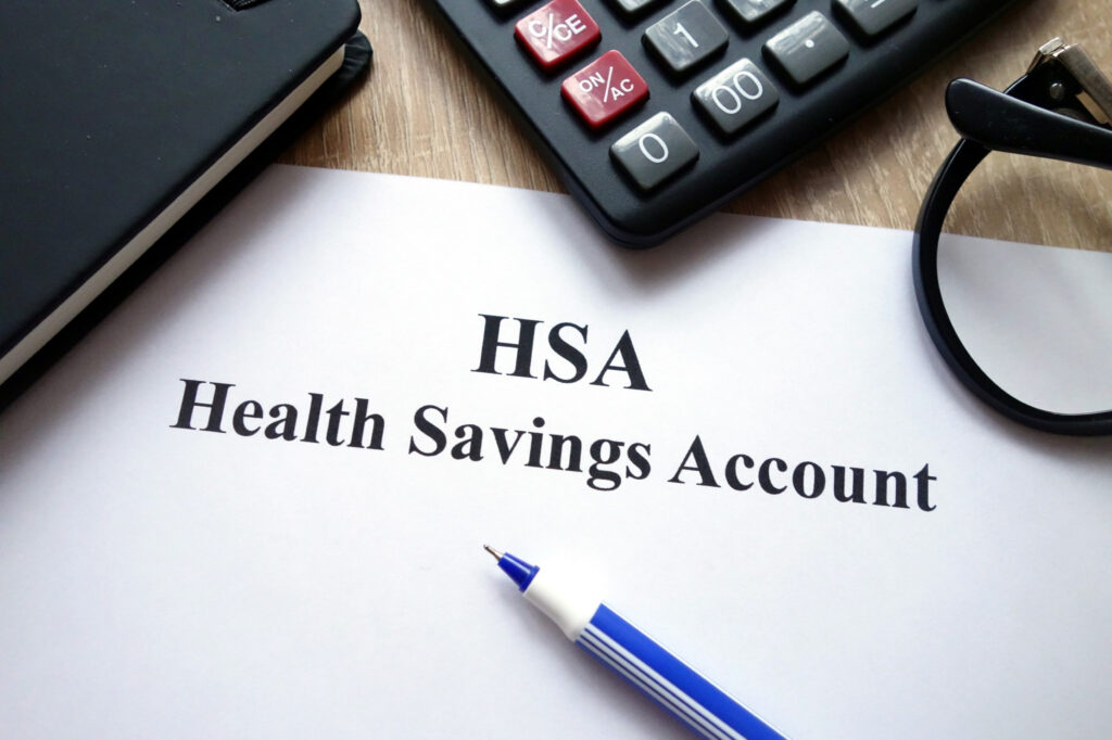 calculator, glasses, and document regarding a health savings account