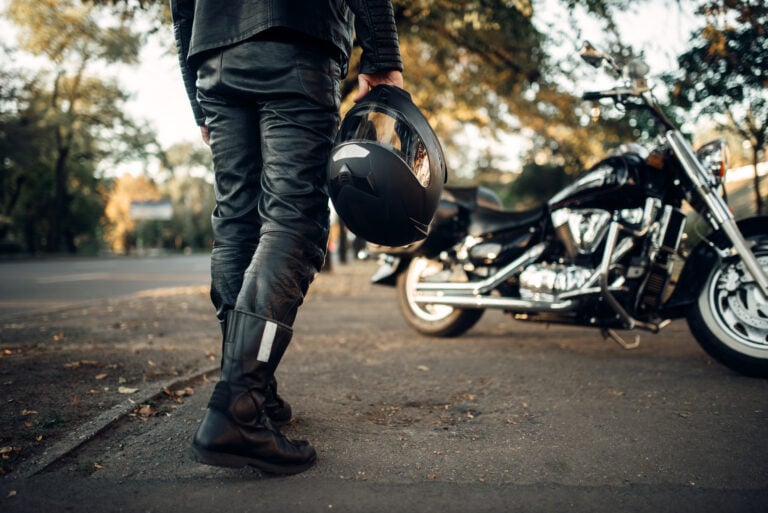 motocycle rider holding a helmet