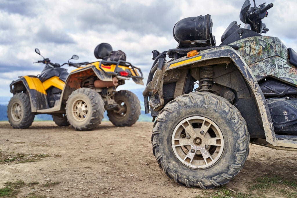 pair of atvs parked overlooking a mountainous area