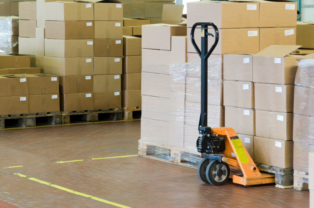 warehouse interior with pallet jack loaded with boxes