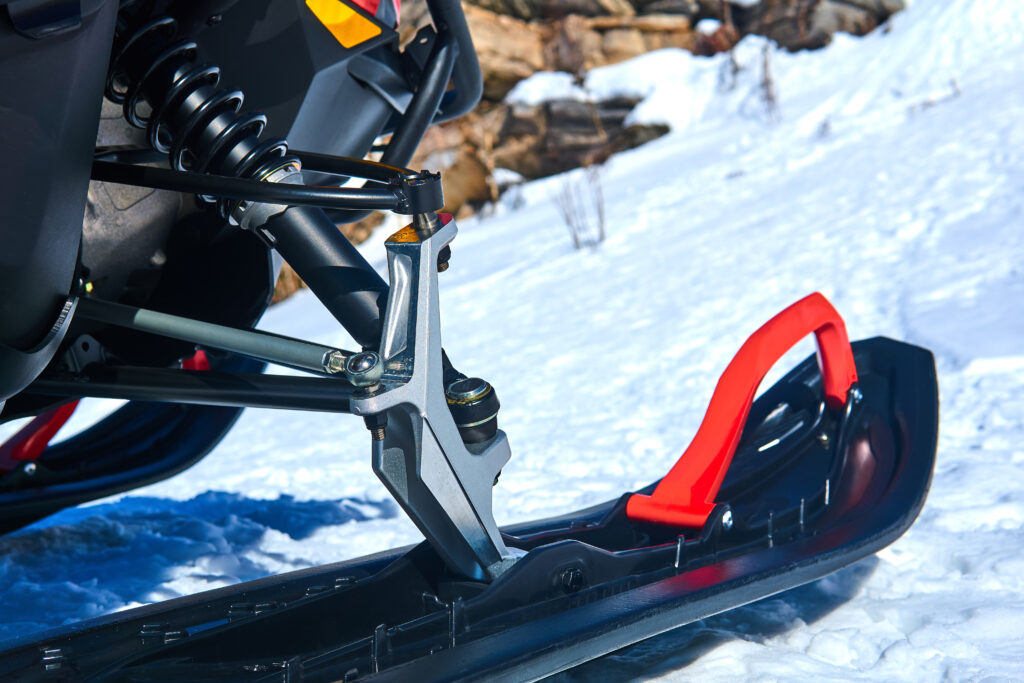 close up of front ski of snowmobile on a mountainous trail