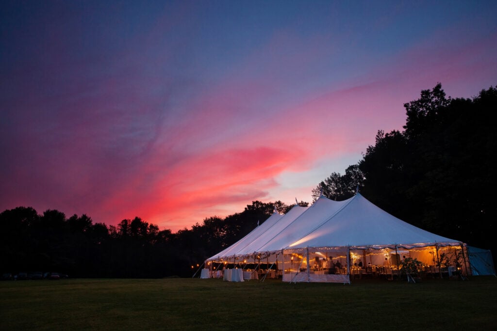 outdoor tent, table, and chairs set up for wedding reception
