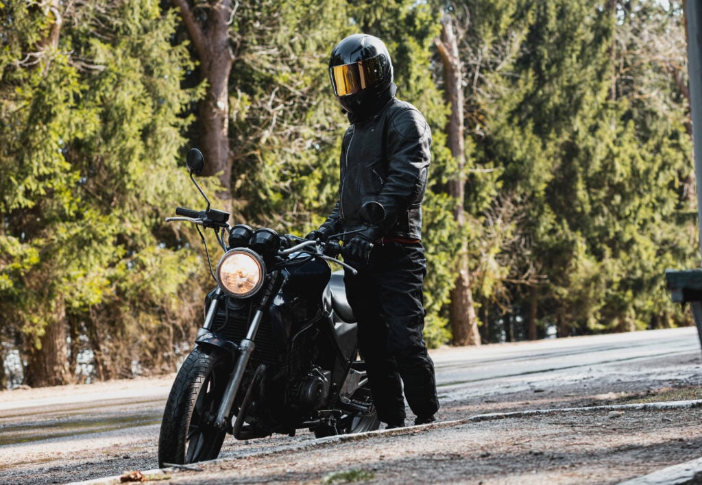 image of biker with motorcycle in protective gear