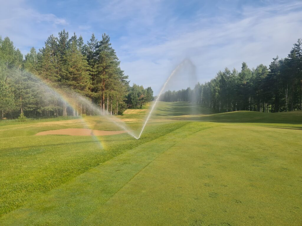 golf course sprinklers watering fairway
