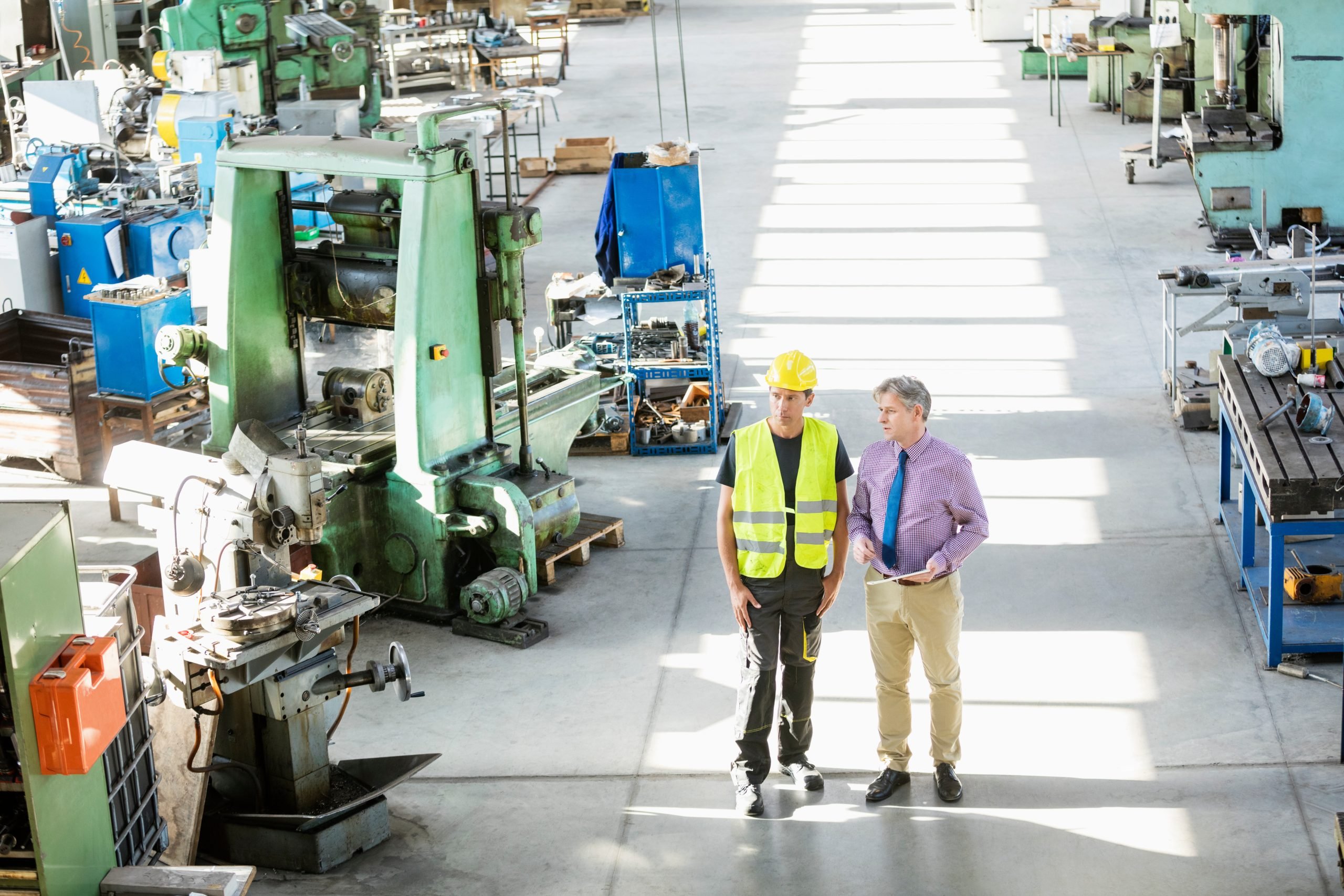 factory worker next to machinery